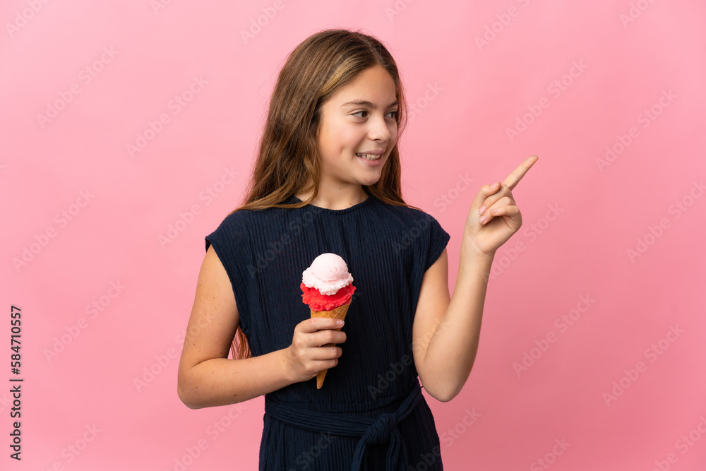 Child with a cornet ice cream over isolated pink background pointing up a great idea Child with a cornet ice cream over isolated pink background pointing up a great idea
