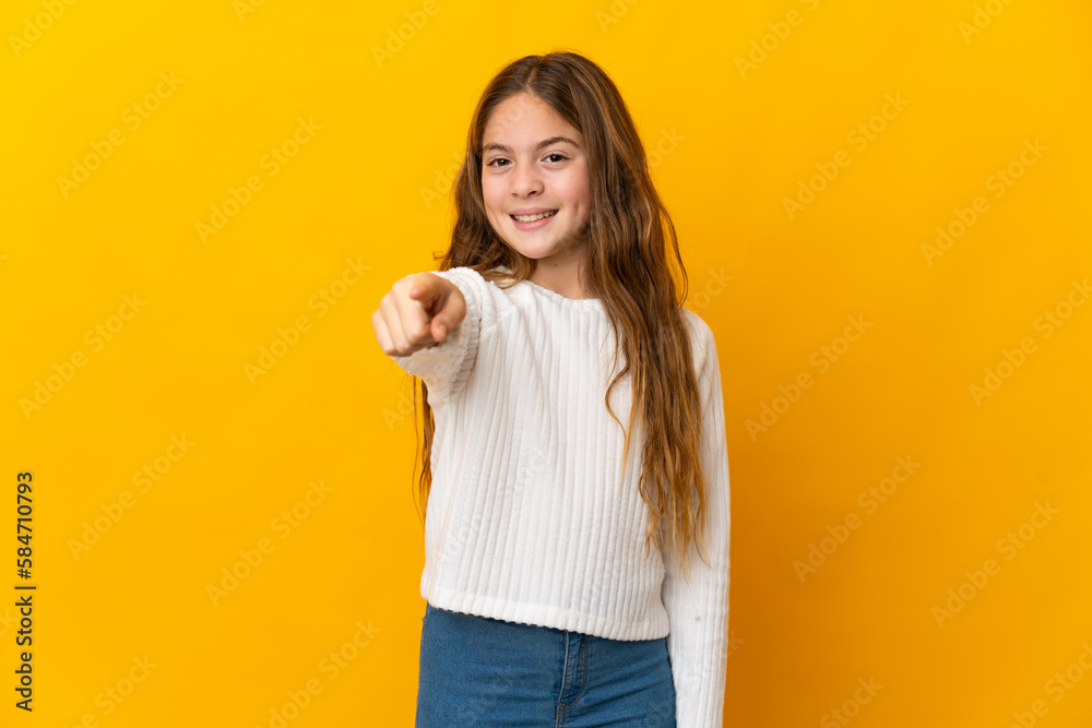 Child over isolated yellow background pointing front with happy expression Child over isolated yellow background pointing front with happy expression