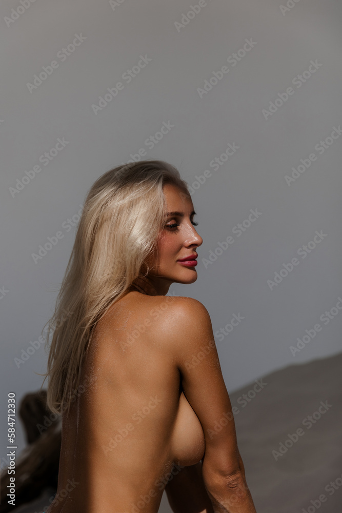 © Anna - Hot beautiful girl in swimsuit panties in bright sunlight. Portrait of a beautiful tanned Caucasian female model with long blonde hair topless standing back. © Anna - Hot beautiful girl in swimsuit panties in bright sunlight. Portrait of a beautiful tanned Caucasian female model with long blonde hair topless standing back.