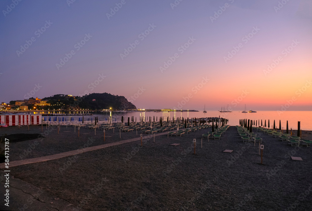 sunset on the beach with yellow sunbeds over the sea and horizon and hills with hotels. Sestri Levante, Liguria, Italy
sunset on the beach with yellow sunbeds over the sea and horizon and hills with hotels. Sestri Levante, Liguria, Italy