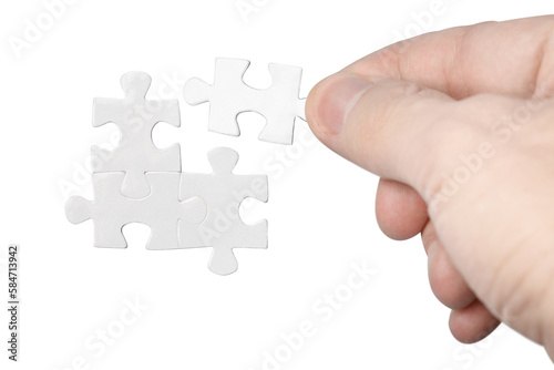 Hand inserting missing piece of puzzle, cut out