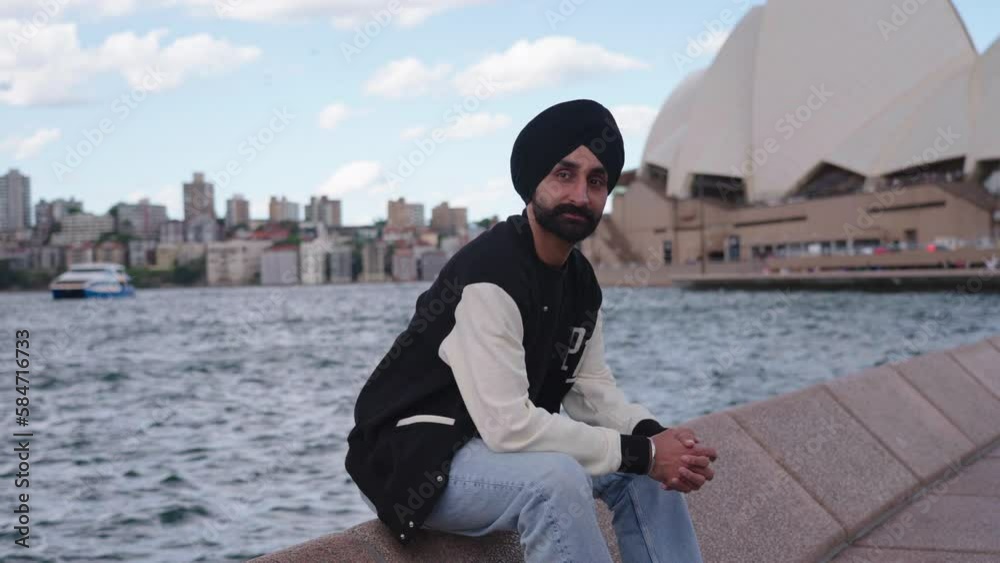 Indian Man In Turban Sitting In Front Of Famous Sydney Opera House In Sydney, Australia. - wide Indian Man In Turban Sitting In Front Of Famous Sydney Opera House In Sydney, Australia. - wide