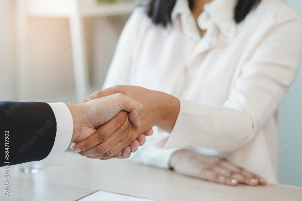 two business people shaking hands after contract is done. two business people shaking hands after contract is done.