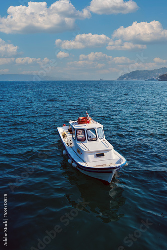 Boat waiting in the middle of the sea © Yalcin