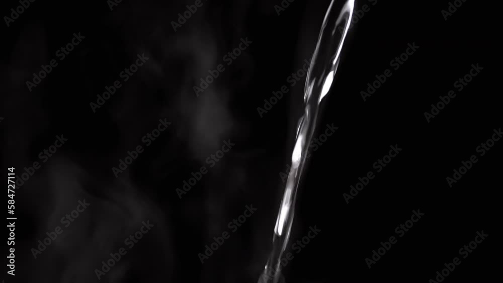 Jet of Hot Boiling Water a Pouring on the Background of Clouds White Steam. Evaporation of steam on a black background. A falling transparent jet of hot water. Splash, drops. Vapor cloud. Blurred fog. Jet of Hot Boiling Water a Pouring on the Background of Clouds White Steam. Evaporation of steam on a black background. A falling transparent jet of hot water. Splash, drops. Vapor cloud. Blurred fog.
