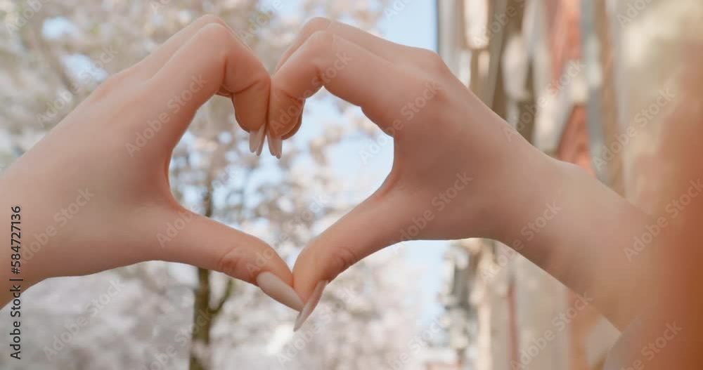 Spring in the City - Cherry blossom - Hands of a young woman held in the shape of a heart - A close-up - The video was shot standing on public ground Spring in the City - Cherry blossom - Hands of a young woman held in the shape of a heart - A close-up - The video was shot standing on public ground