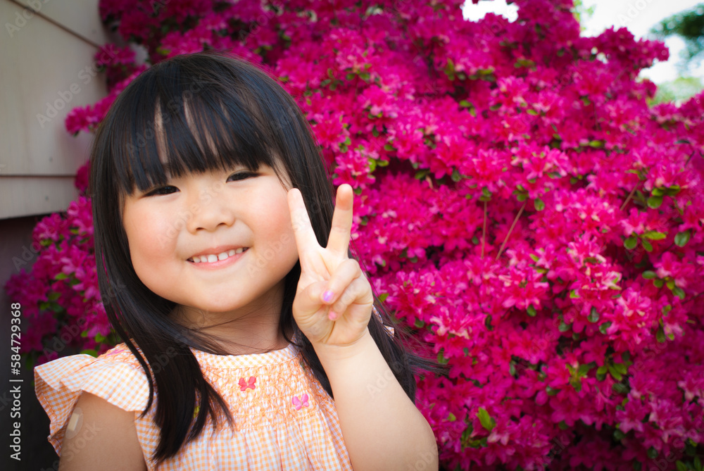Young asian girl with long black hair posing in front of spring flower Young asian girl with long black hair posing in front of spring flower