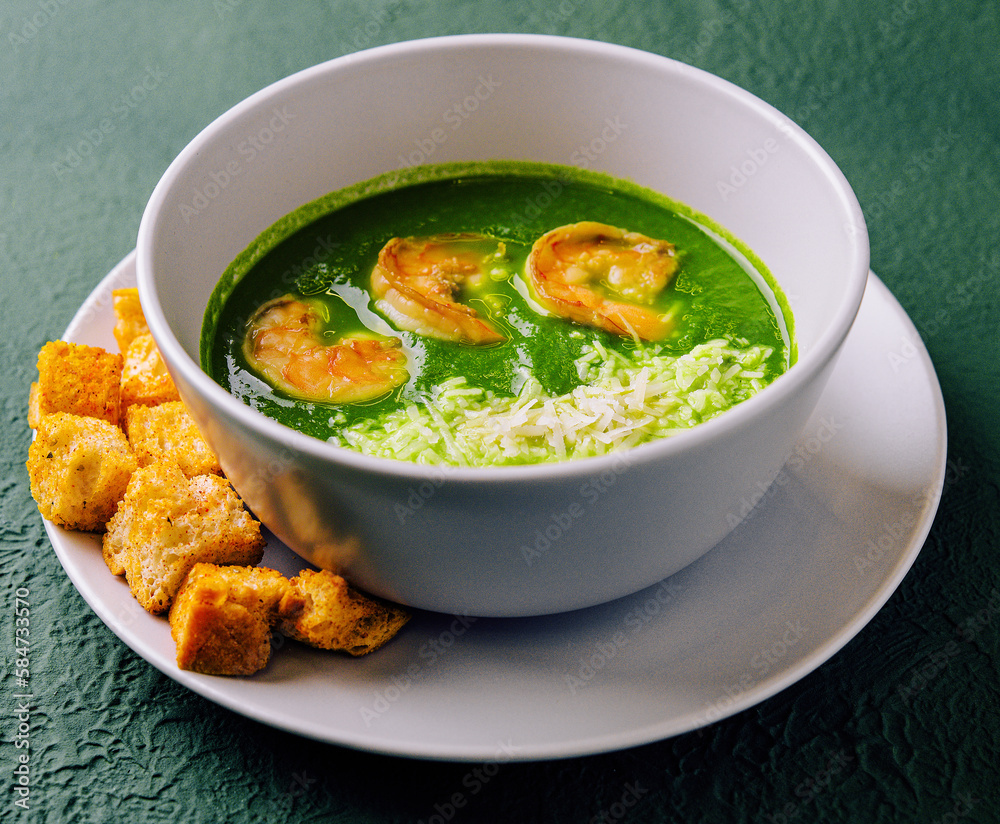 Broccoli green cream soup with shrimps