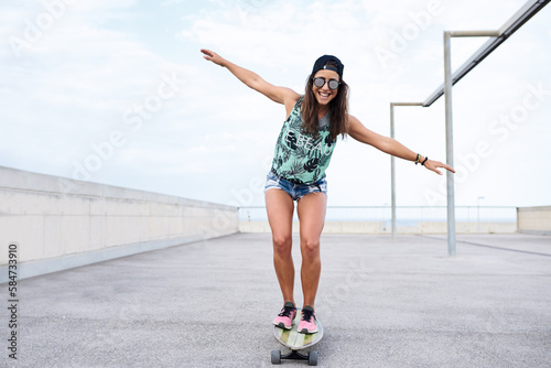 Canvas Print Happy girl balancing on skateboard.