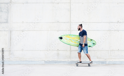 Man skating with surfboard.
