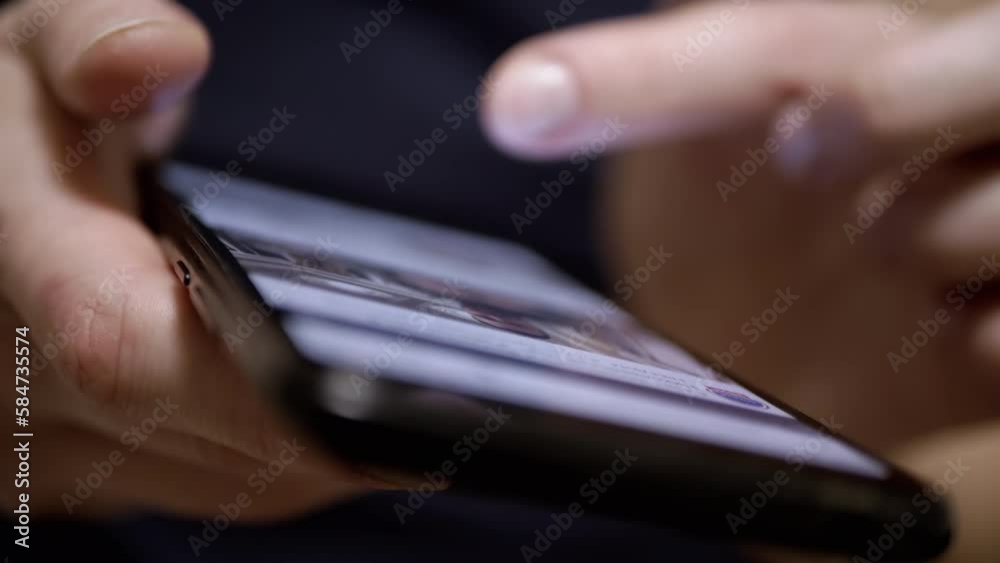 Female Fingers Scroll through the News Feed in Social Networks on a Mobile Phone. Close-up. A woman browsing mobile applications on a smartphone. Fingers touch the screen. Life in a smartphone. Female Fingers Scroll through the News Feed in Social Networks on a Mobile Phone. Close-up. A woman browsing mobile applications on a smartphone. Fingers touch the screen. Life in a smartphone.