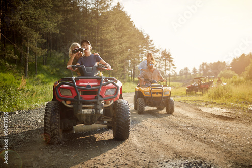 Group of avanturistic friends driving quads