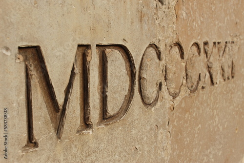 macro ancient roman numerals etched in stone (Maison Carrée, Nimes, France)