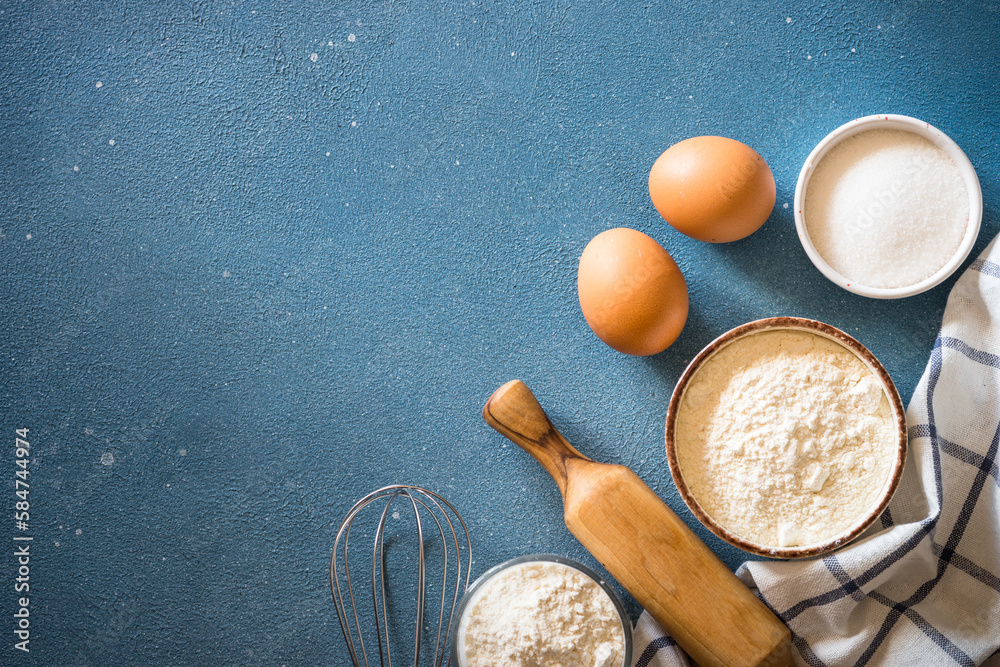 Baking background at blue stone table. Flour, sugar, eggs and utensil. Top view with copy space. Baking background at blue stone table. Flour, sugar, eggs and utensil. Top view with copy space.