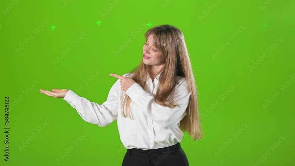 Front view of positive, young lady wearing offiical clothes, showing. Attractive, blonde woman looking at camera, stretching hand, pointing by finger. Concept of modern lifestyle. Front view of positive, young lady wearing offiical clothes, showing. Attractive, blonde woman looking at camera, stretching hand, pointing by finger. Concept of modern lifestyle.
