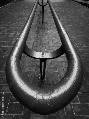 Black and white closeup image of a walkway handrail.