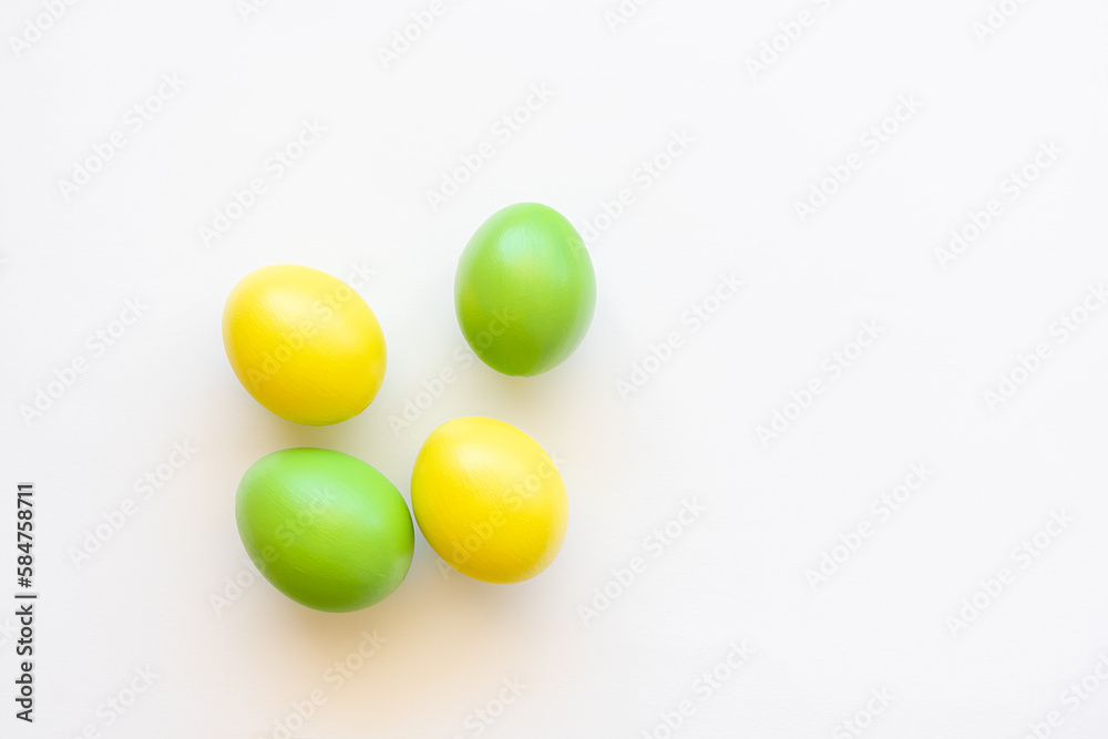 Easter eggs in yellow and green on a white background.