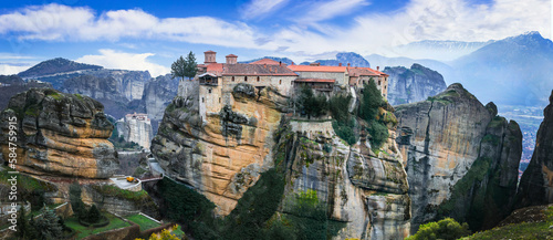 Mysterious monasteries hanging over rocks of Meteora, Greece - most famous landmarks and beautiful places photo