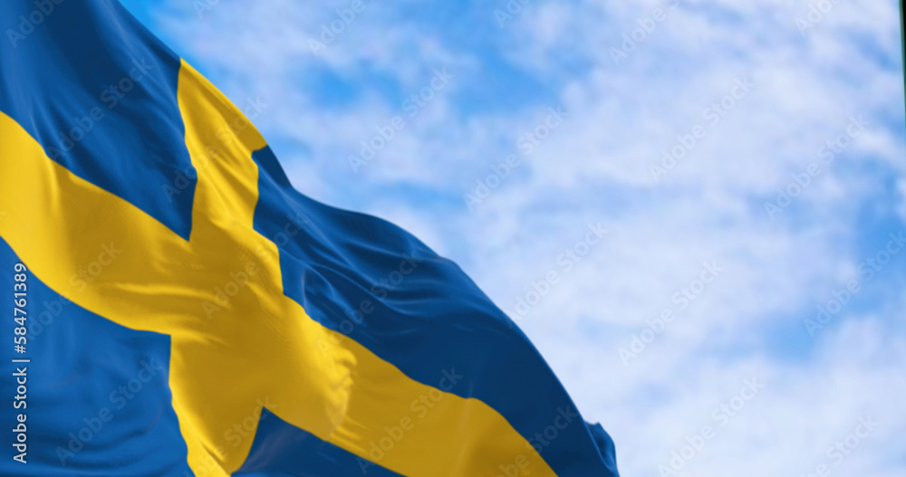 The national flag of Sweden waving on a clear day - obrazy, fototapety, plakaty 