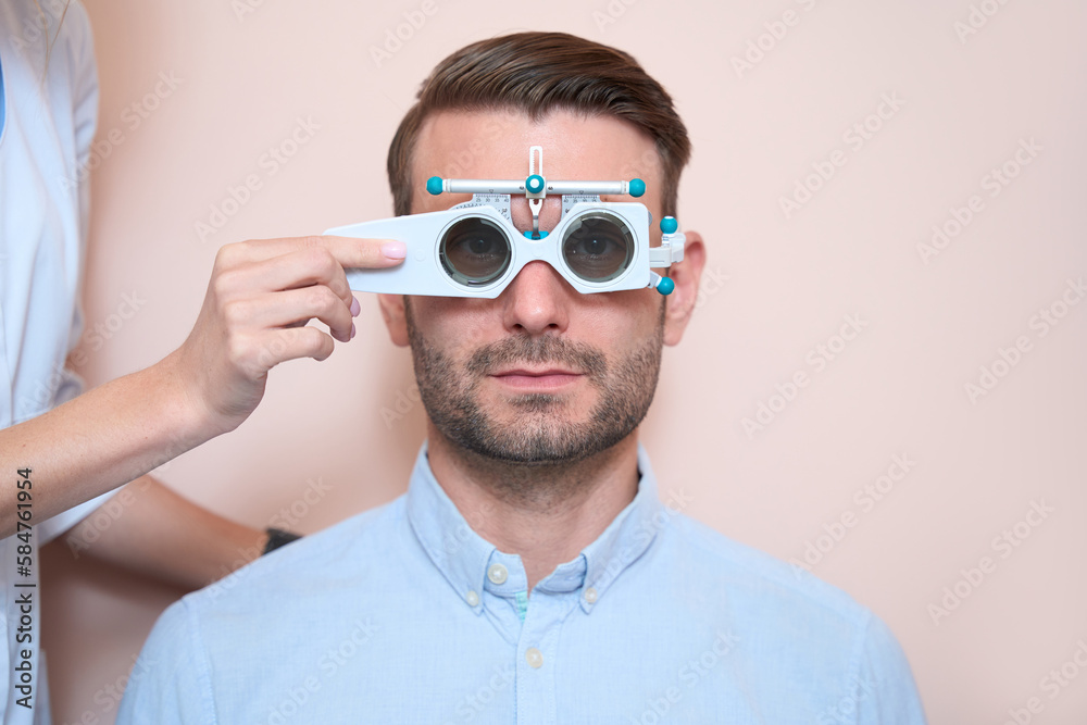 Confident man in blue shirt is looking ahead in trial frame Confident man in blue shirt is looking ahead in trial frame