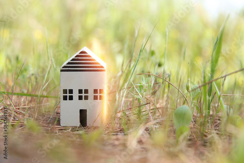 Concept image of a small house in nature. Idea of ecology, solar energy, and sustainability