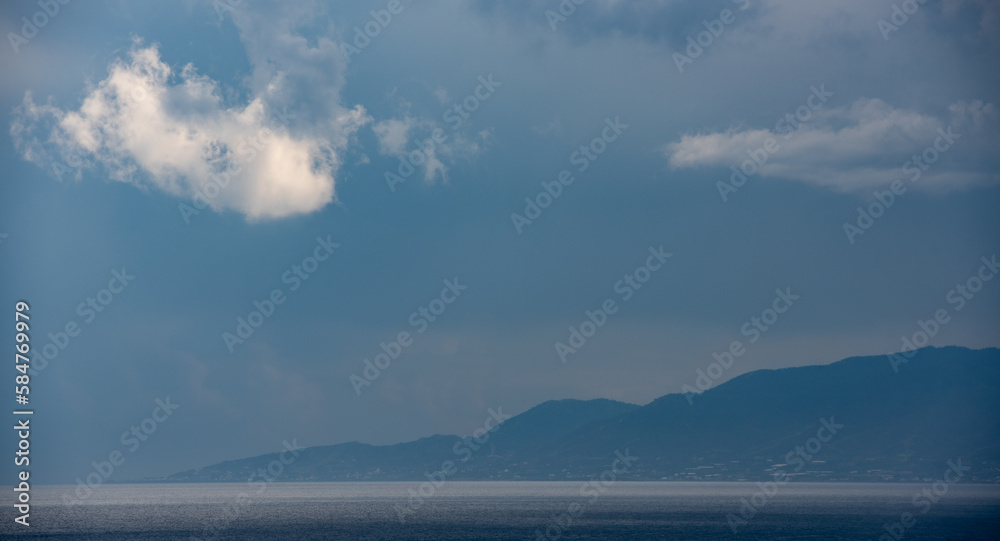 Seascape , white cloud above the mountain on a  stormy day.