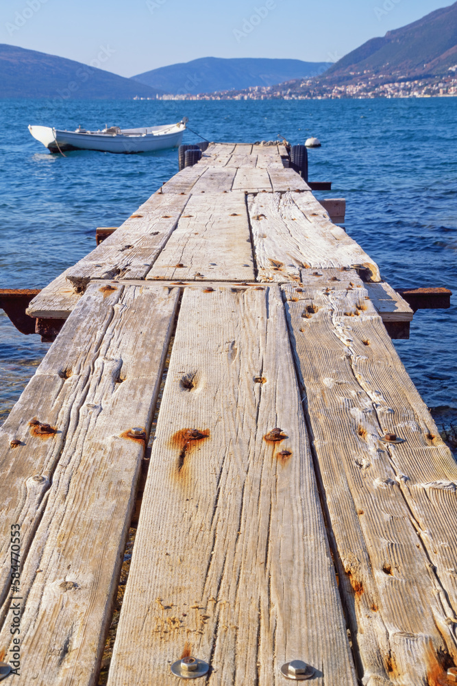 Fototapeta premium Old wooden pier on coast of Bay of Kotor, Tivat. Montenegro