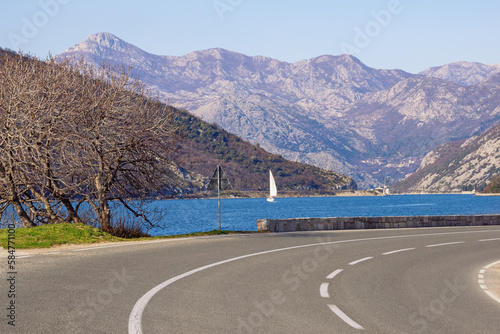 Balkan road trip.  Beautiful Mediterranean landscape on sunny March day. Sharp turn of road of Adriatic Highway  Montenegro,  Bay of Kotor, Tivat photo