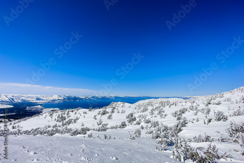 Breathtaking Lake Tahoe Panorama - Snowy Peaks and Clear Sky
