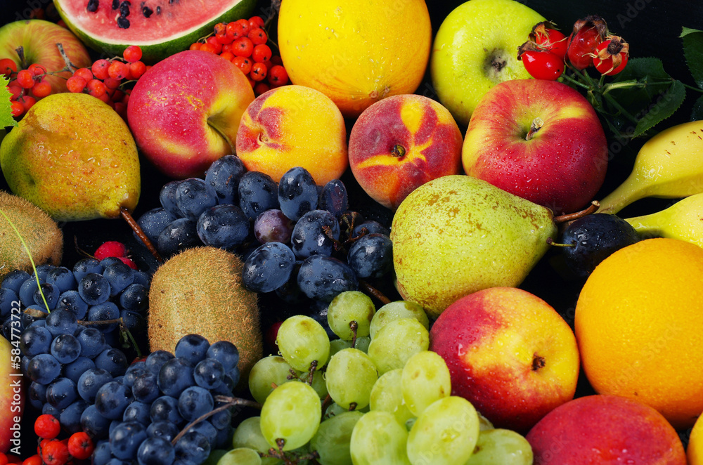 A variety of fruits on a wooden table. A variety of fruits on a wooden table.