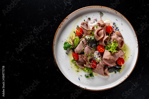 Beef tongue salad with fresh vegetables in plate
