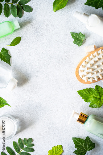 Natural cosmetic concept. Skin care product, cream, soap, tonic, mask with green plants. Flat lay image.