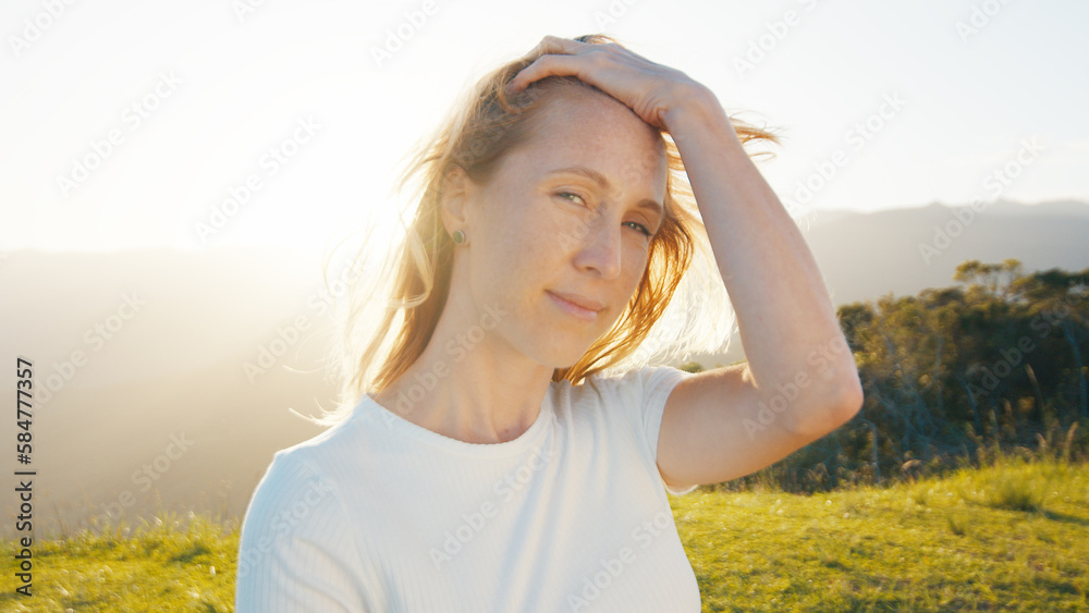 Portrait of the young caucasian woman outdoor at sunrise. Model looks into the camera Portrait of the young caucasian woman outdoor at sunrise. Model looks into the camera