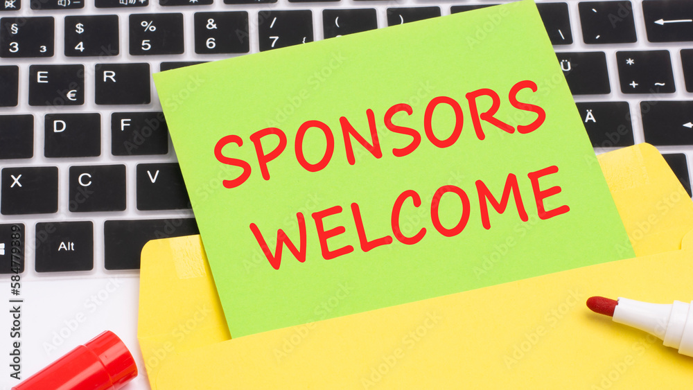 text SPONSORS WELCOME is written in red marker on a green card. in the frame is a laptop keyboard on yellow notepad. concept of business and finance. text SPONSORS WELCOME is written in red marker on a green card. in the frame is a laptop keyboard on yellow notepad. concept of business and finance.