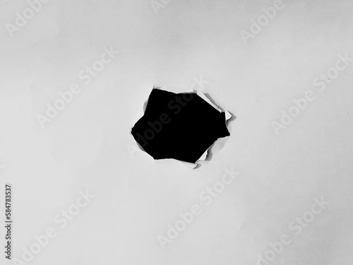 paper frame with the ripped holes. a black hole on the white paper. for copy space background overlay