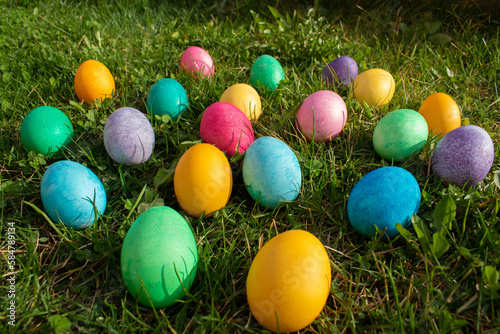 Happy Easter. Easter eggs on the grass on a sunny spring day - Easter decoration  banner  panorama  background with space for text.