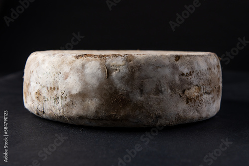 Tome de Savoie, French cheese isolated on black background