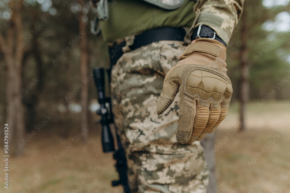 military hand.Camouflage tactical gloves. Khaki tactical gloves