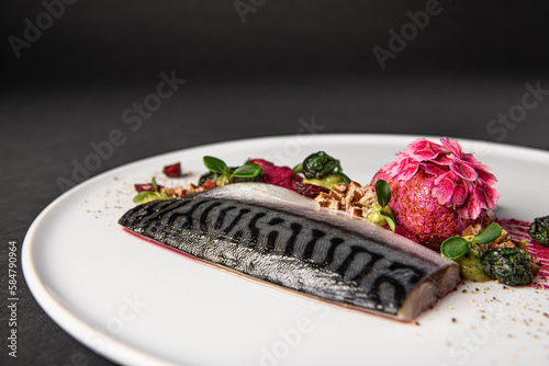 Gourmet and gastronomic fish dish isolated on a black background photo