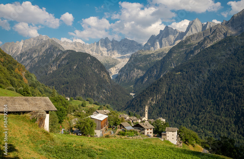 The Soglio village and Piz Badile, Pizzo Cengalo, and Sciora peaks in the Bregaglia range - Switzerland.