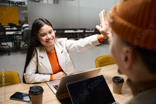 Photography Joyful female entrepreneur greeting her counterpart in meeting room