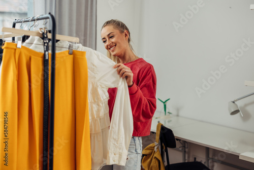 A Young woman is choosing what t wear