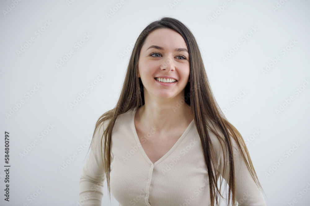 Pretty smiling joyfully female with fair hair, dressed casually, looking with satisfaction at camera being happy Studio shot of good-looking beautiful woman isolated against blank studio wall Pretty smiling joyfully female with fair hair, dressed casually, looking with satisfaction at camera being happy Studio shot of good-looking beautiful woman isolated against blank studio wall