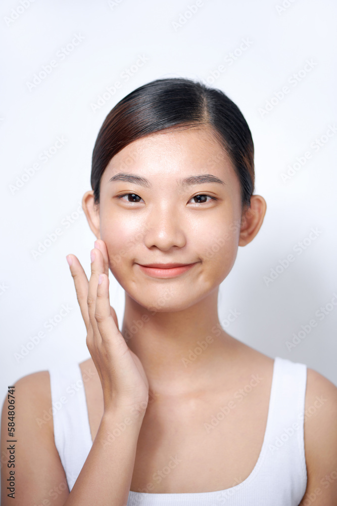 Enjoying her soft skin. Beautiful young woman touching her face Enjoying her soft skin. Beautiful young woman touching her face