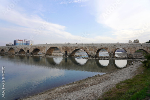 old stone bridge over the seyhan river adana photo