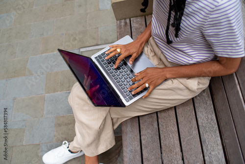 Anonymous Student With Laptop Outdoors  photo
