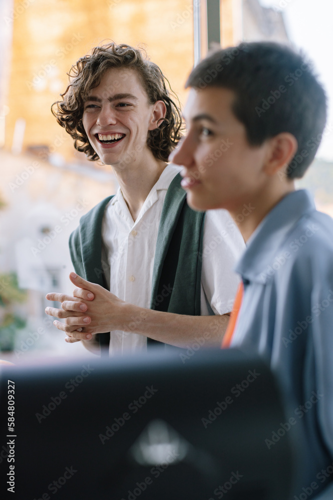 Young Man is Laughing Looking at His Androgynous Girlfriend Young Man is Laughing Looking at His Androgynous Girlfriend