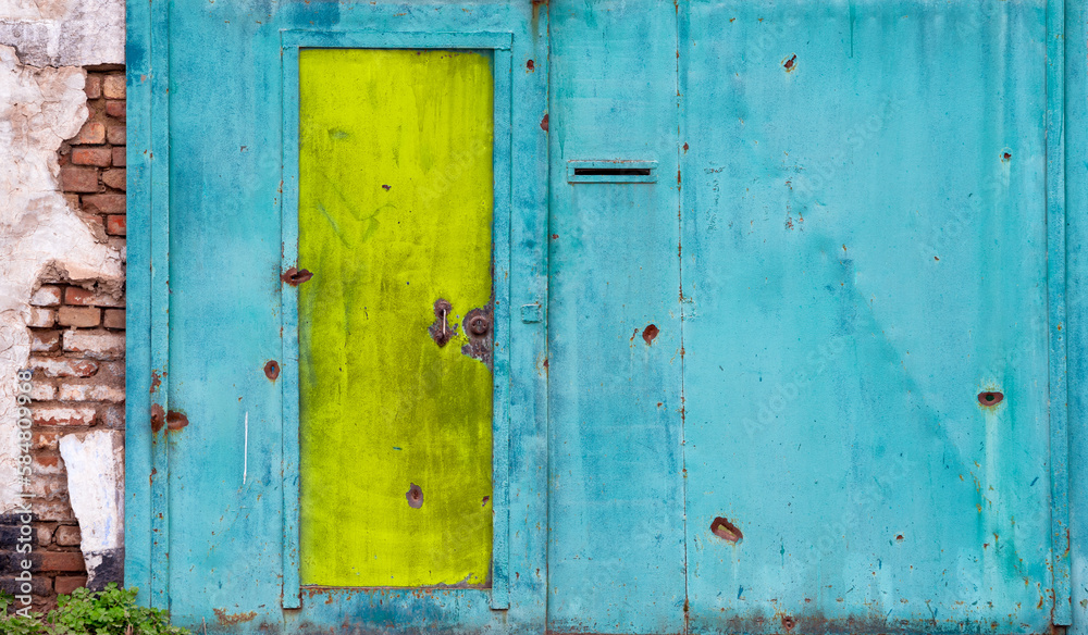 damaged blue yellow house wall war in Ukraine