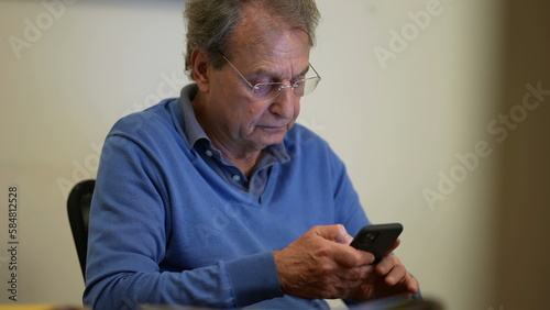One senior business man working in front of computer screen. Older mature entrepreneur reading content online