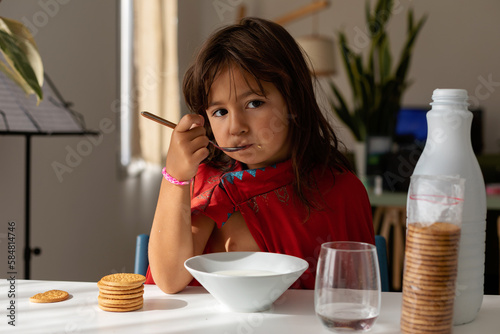 5 years old girl eating breakfast